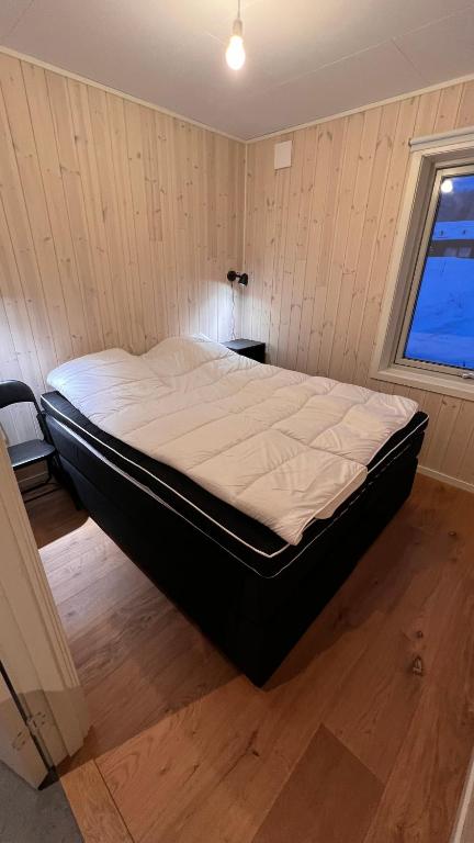 a large bed in a room with a window at Perfect winterhouse in Sälen in Sälen