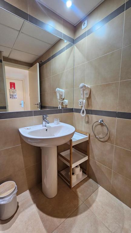 a bathroom with a sink and a mirror at Esmeralda Suites Sunrise in Calpe