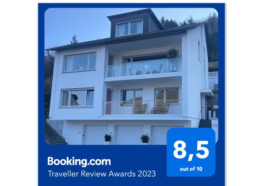 a poster of a white house with the words booking com traveler review awards at Gästehaus Paulina in Cochem