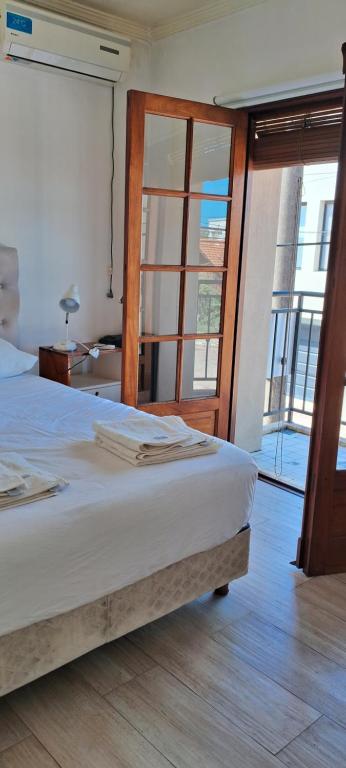 a bedroom with a bed and a sliding glass door at DUPLEX in Gualeguay