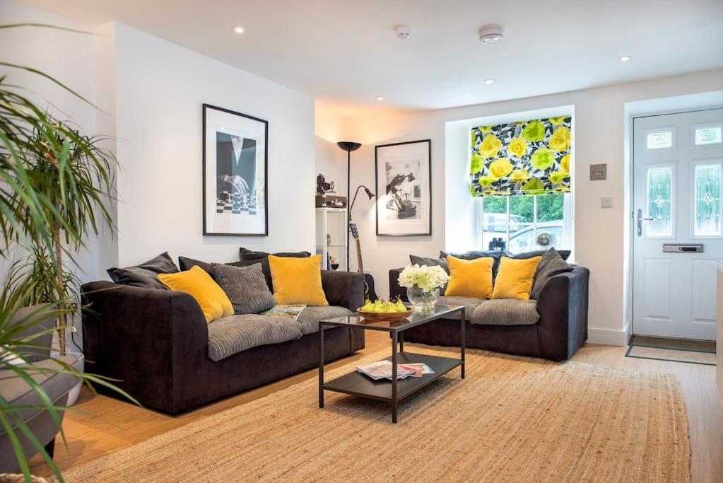 a living room with a couch and a table at Luxury Town House in Tavistock Sleeps 8 in Tavistock