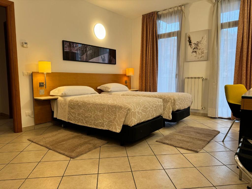 Postel nebo postele na pokoji v ubytování Residence Malpensa