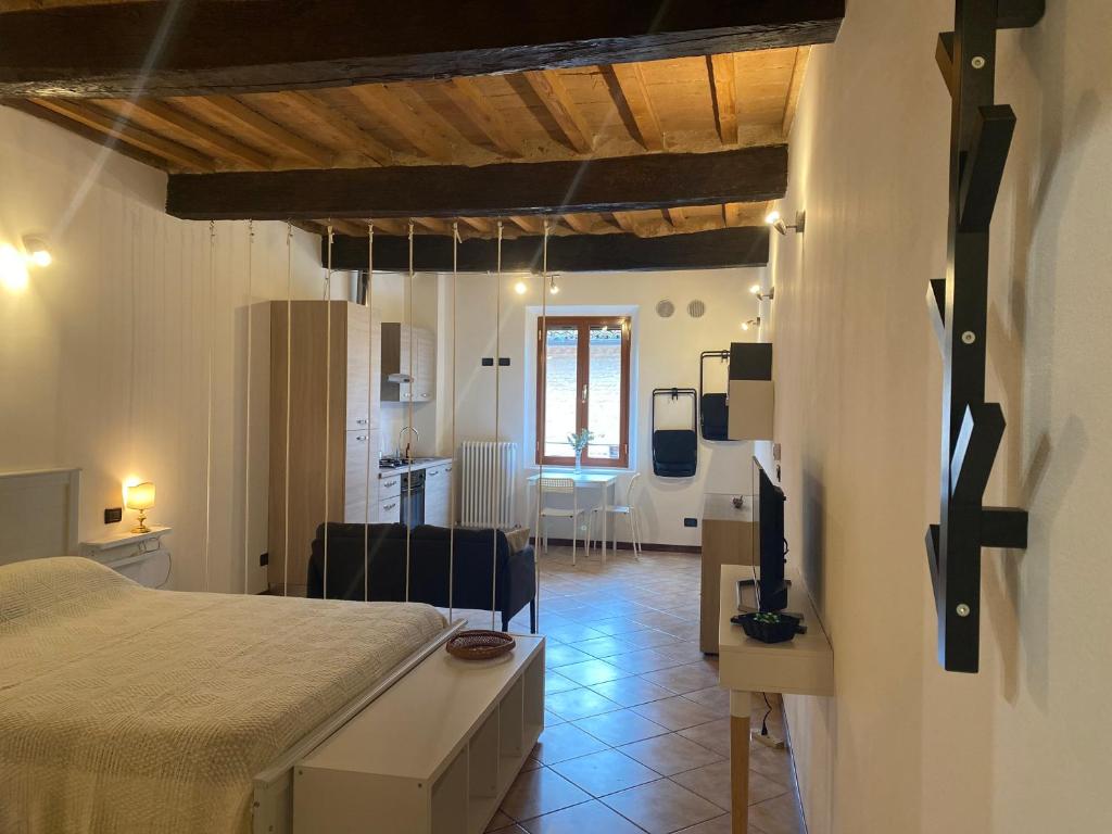 a bedroom with a bed and a living room at Teatro Inn - Timeless Charm in Correggio