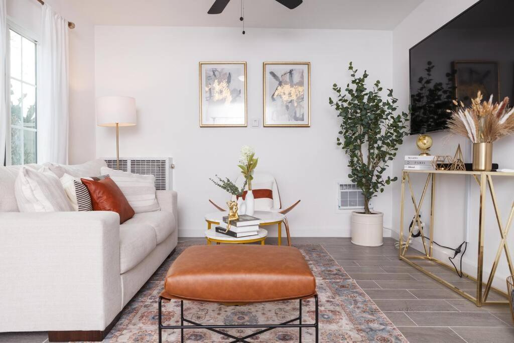 a living room with a white couch and a stool at A stunning 2bedroom 2bath private home near Sofi Stadium, Kia Forum, and Intuit Dome in Los Angeles