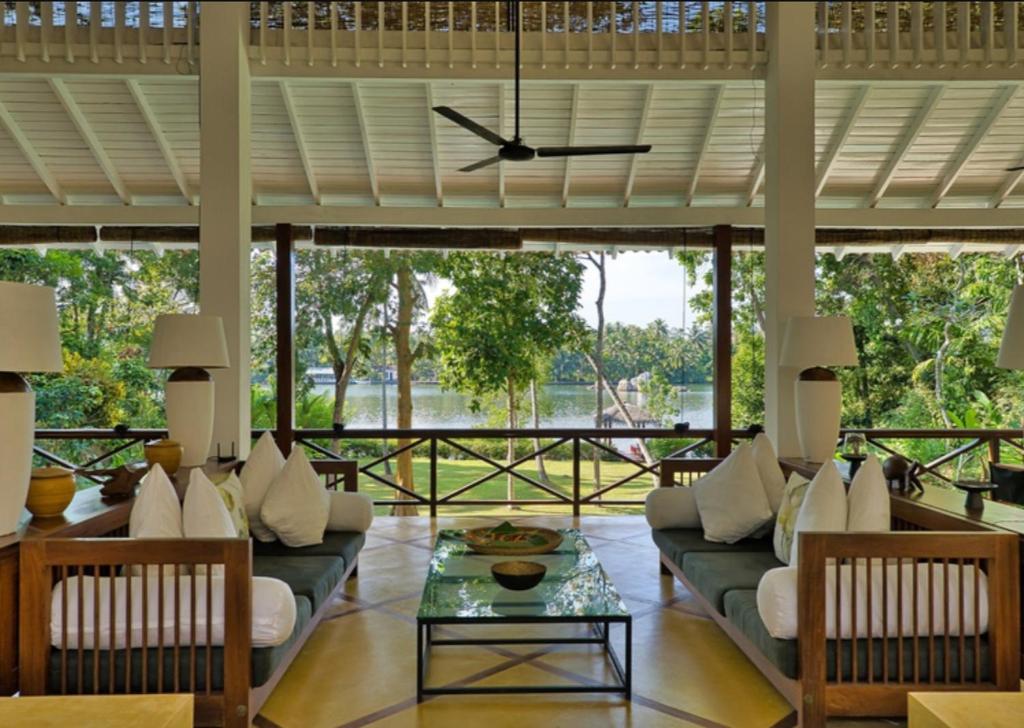 a living room with couches and a table at The Lake House Koggala in Galle