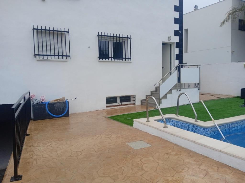 a room with a pool and stairs in a building at Sofia home in San Antonio de Benagéber