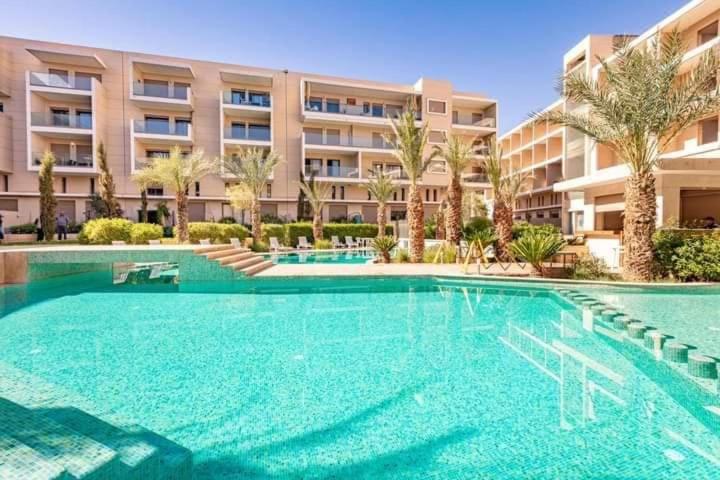 una gran piscina frente a un edificio en Appartement La Perle en Marrakech