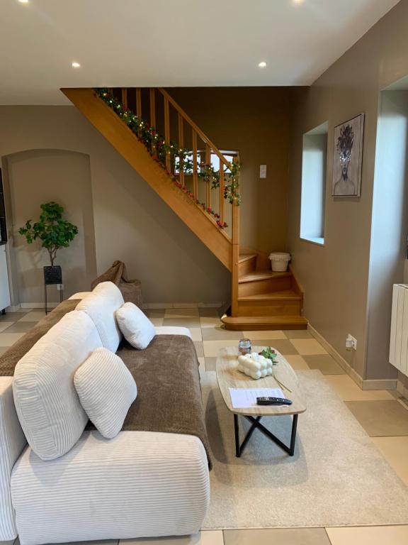 uma sala de estar com um sofá e uma escada em Les Almadies private Jacuzzi em Villeneuve-les-Sablons