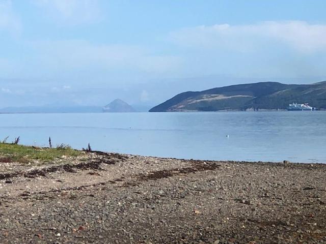 a large body of water with mountains in the background at Lochside Retreat, Stranraer - Cottage by the loch! in Stranraer