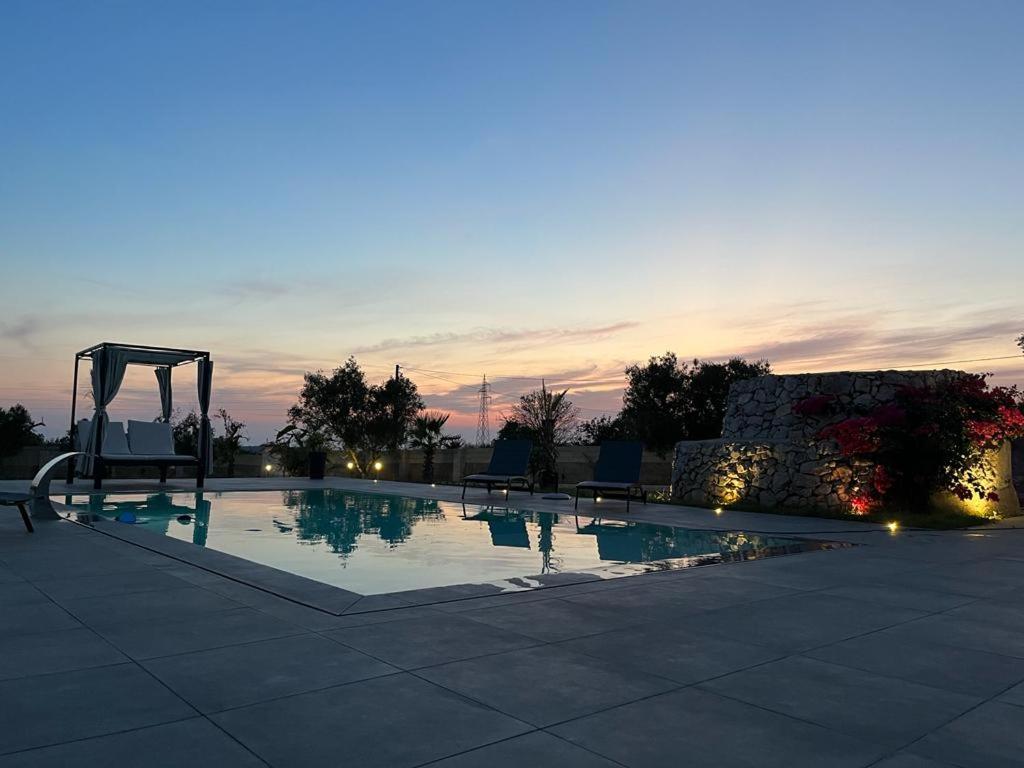 a swimming pool with a slide and a playground at VILLA ASTORE in Ruffano