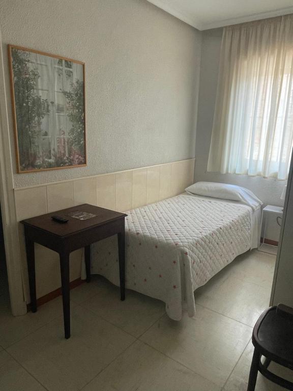 Postel nebo postele na pokoji v ubytování Hostal Ochoa