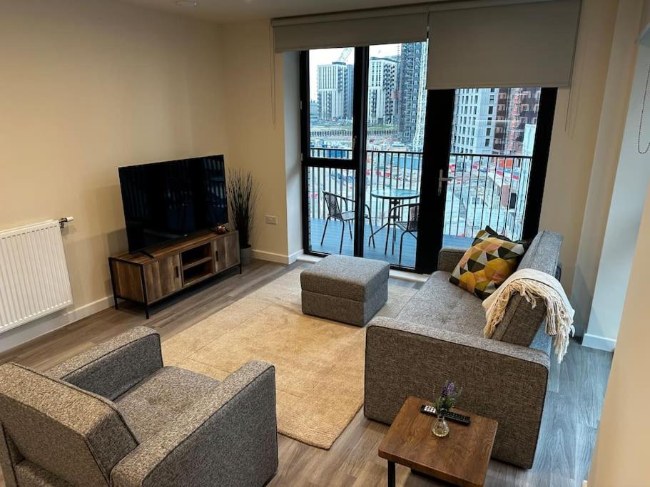 a living room with two couches and a television at Luxury Apt in Wembley Park Perfect for Events & Exploring London in London