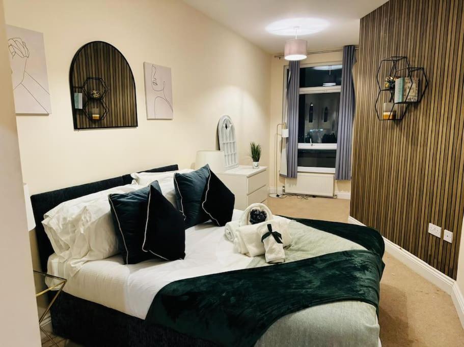 a bedroom with a bed with a teddy bear on it at Mesh Accommodation Ashford Town Centre 2 Bed Apartment for Contractors, Families, Relocators with Parking in Kent