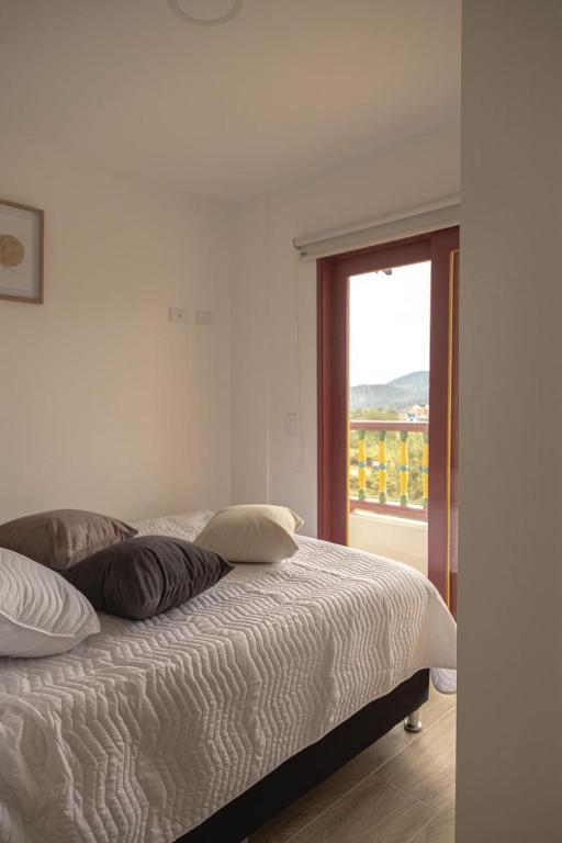 Postel nebo postele na pokoji v ubytování Loma Rent Home Guatape