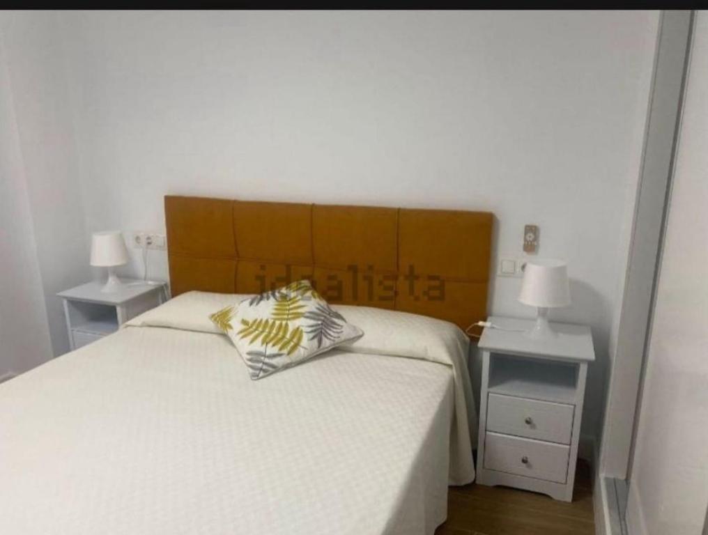 a bedroom with a bed and two night stands at Castel Málaga Home in Málaga