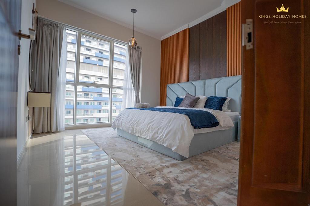 a bedroom with a bed and a large window at Dunya tower Royal suite Burj Khalifa street, Kings in Dubai