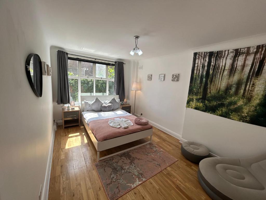 a bedroom with a bed and a large window at Marble Arch 3-Bedroom Family Flat in Central London in London
