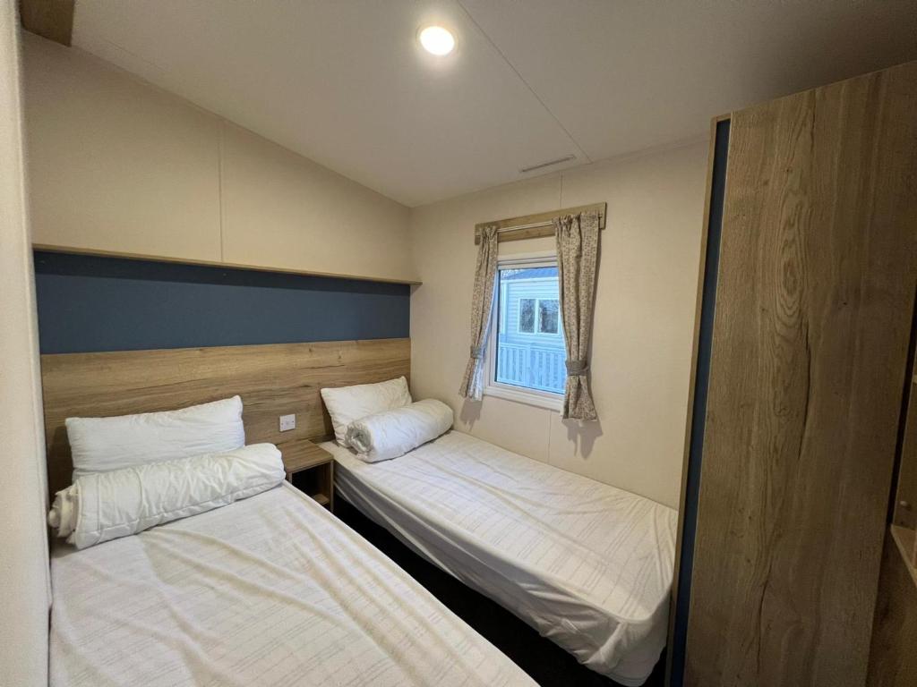 A bed or beds in a room at Laguna- Rockley Park Poole