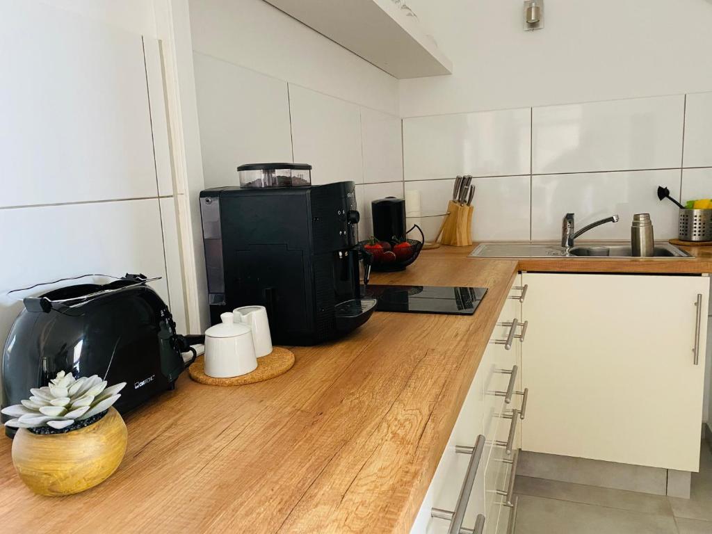 a kitchen with a counter top with a coffee maker at Ferienwohnung DECK 3 in Cuxhaven in Cuxhaven