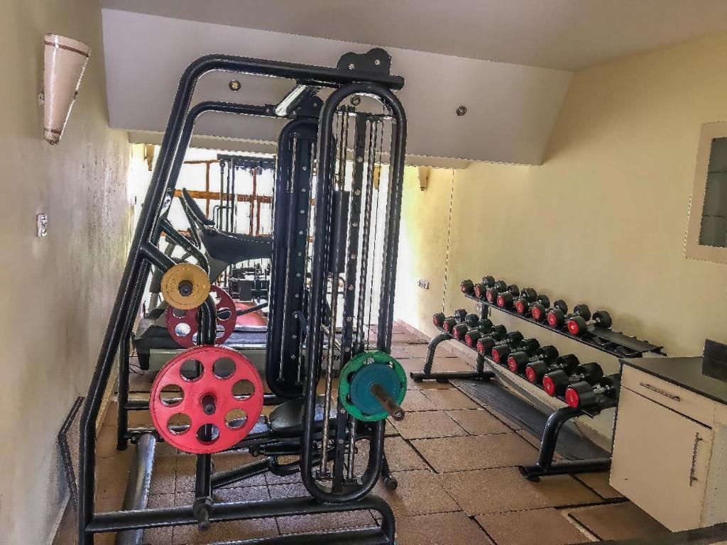 a gym with a bunch of dumbbells at Harmony Homes Beachfront in Diani Beach