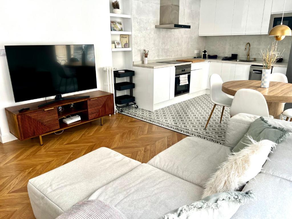 sala de estar con sofá blanco y TV en Apartamento Marqués de Villores centro, en Albacete