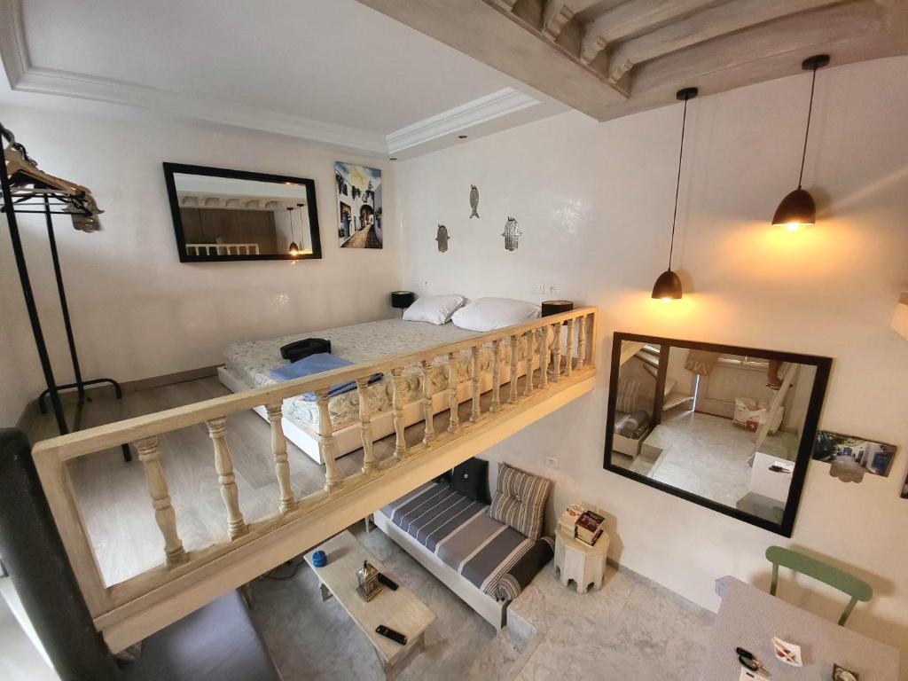 a bedroom with a loft bed and a mirror at Beautiful studio in the center of sidi bou said village in Sidi Bou Saïd