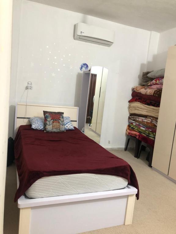 a bedroom with a bed and a mirror at Family House in Al Azraq ash Shamālī