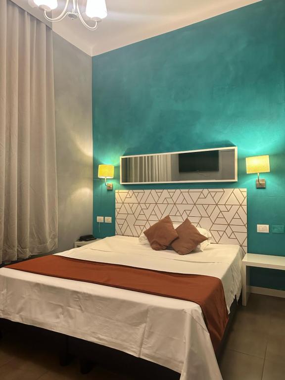 a bedroom with a bed with a blue wall at Villa Giovanna Citylife Milano in Milan