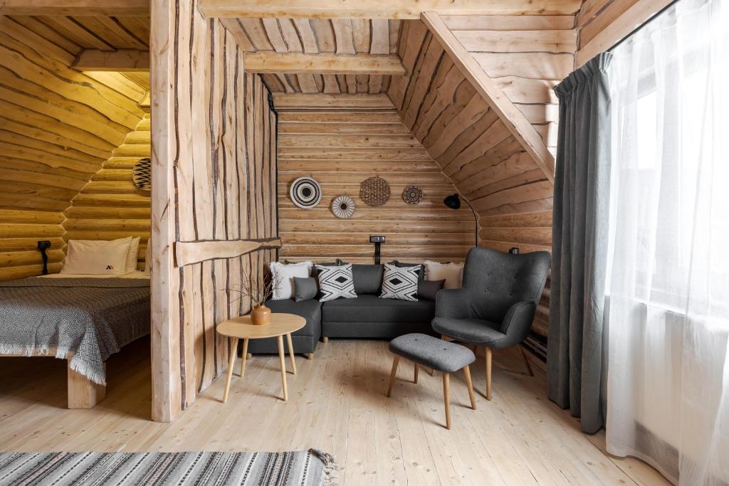 una camera con letto, divano e sedia di Gremi Hotel a Dragobrat