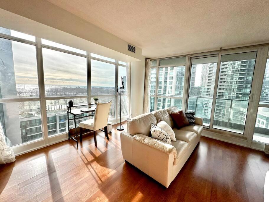 a living room with a couch and a table at Lake View Apartment w/Parking! in Toronto