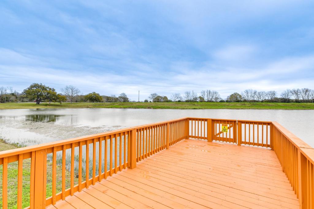 a wooden deck with a view of a body of water at Angleton Vacation Rental with On-Site Lake Access! in Angleton