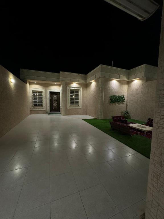 a large empty room with a patio at night at الجود مخيم شقة استراحة بيت in Khamis Mushayt
