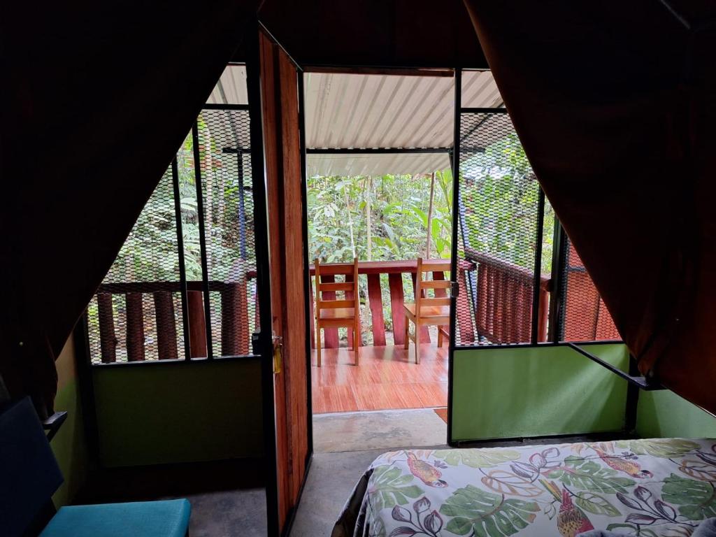 a view of a room with a bed and a balcony at Guapote Lodge in Tigra