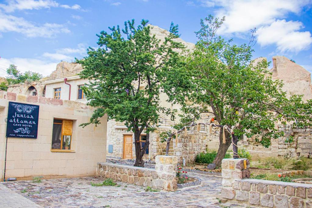 an old stone building with trees in front of it at Junior Ottoman Cave in Urgup