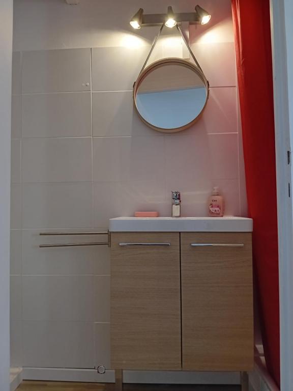 a bathroom with a sink and a mirror at Centre ville d'Amelie les bains in Amélie-les-Bains-Palalda