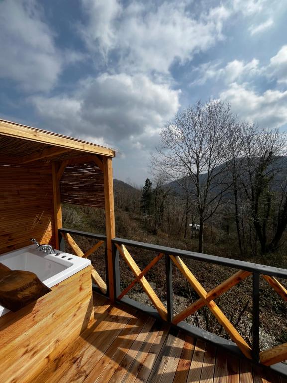 a hot tub on a deck with a view of the mountains at Sapanca Sis Vadi Bungalov in Sakarya