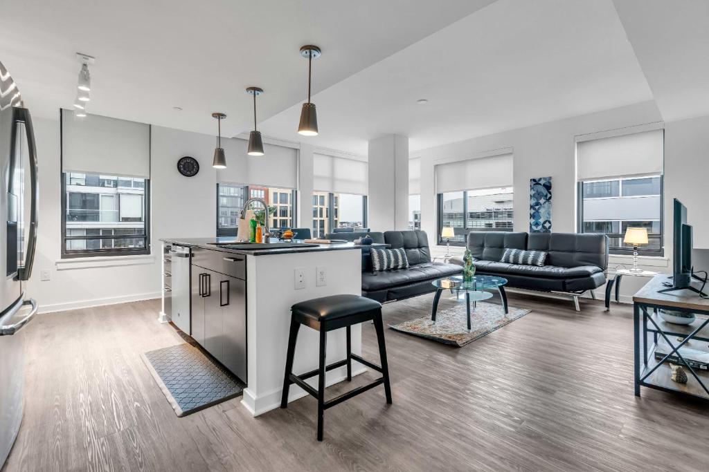 a living room with a kitchen and a living room with furniture at 2BR Furnished Apartment Near Nationals Park in Washington, D.C.