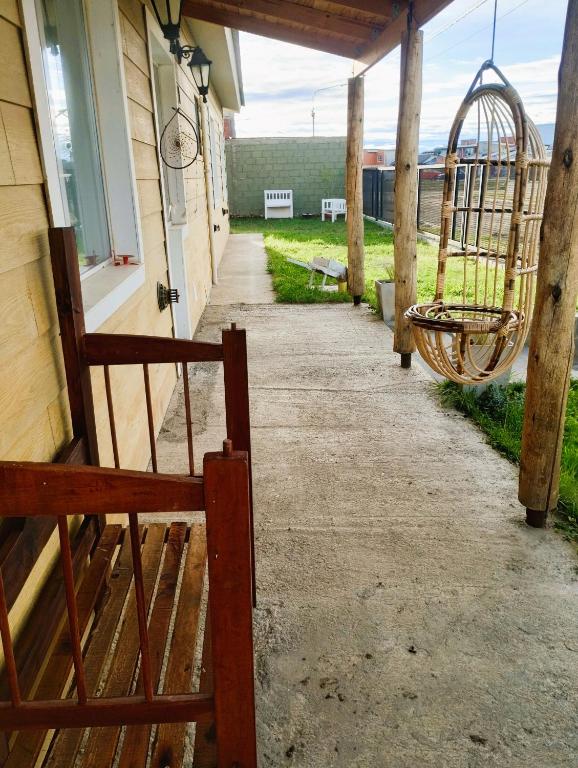 a porch of a house with a swing at ESTEPA CHIMEN in Río Gallegos