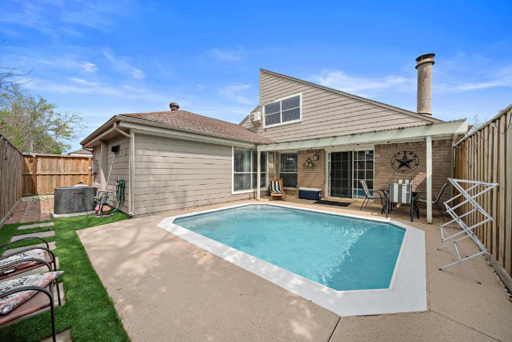 a swimming pool in the backyard of a house at Houston Pool Getaway Games Parking Wifi Pet in Houston