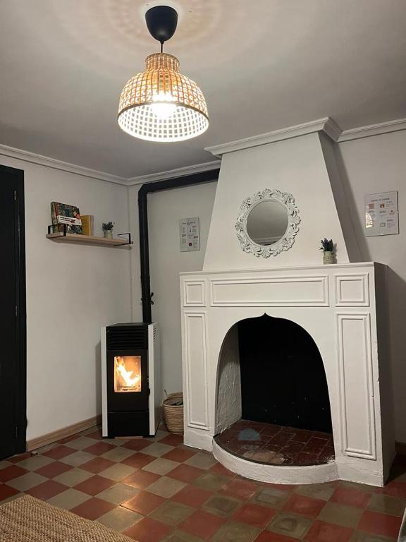 a living room with a fireplace and a chandelier at Casa Sina in Riópar