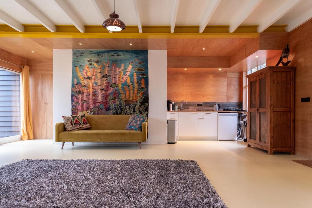 a living room with a couch and a painting on the wall at Dream apartments in Hoogwoud