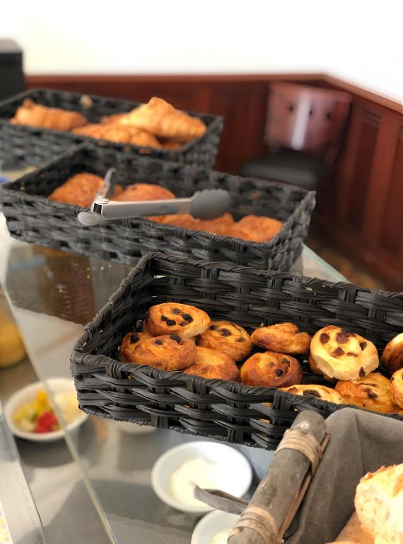two baskets filled with pastries on a table at Grand hôtel de l&#39;Europe in Vals-les-Bains