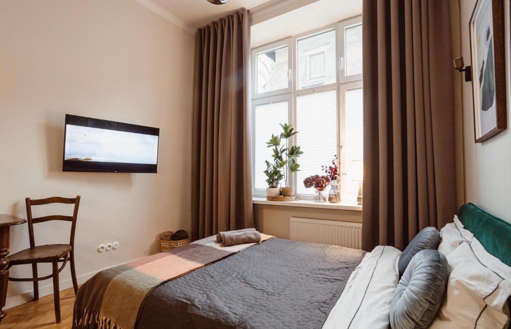 Posteľ alebo postele v izbe v ubytovaní Apartament na Krakowskim Kazimierzu