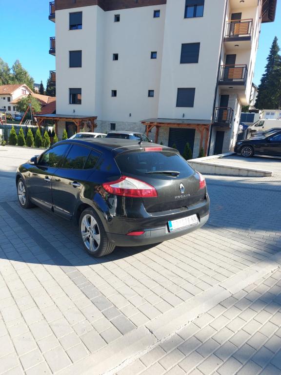 a black car parked on the side of a street at Carpe Diem in Zlatibor