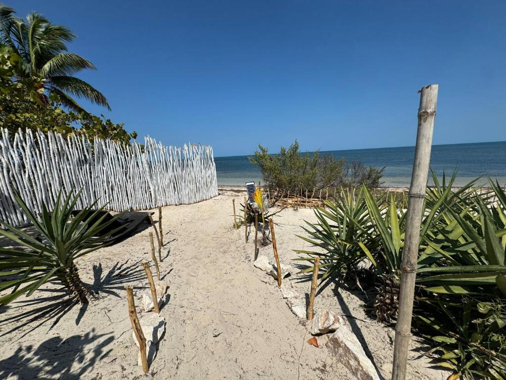 a fence on a beach with the ocean in the background at Casa Arsha Beachfront Paradise in Santa Clara