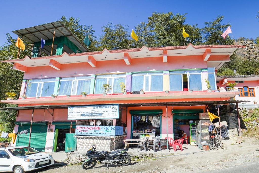 a building with motorcycles parked in front of it at OYO 66014 The Rudralok Hotel in Gopeshwar