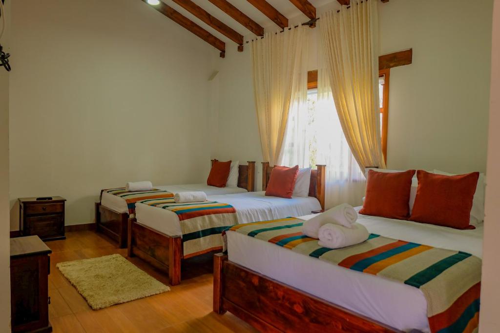 Postel nebo postele na pokoji v ubytování Hotel Gran Sirius