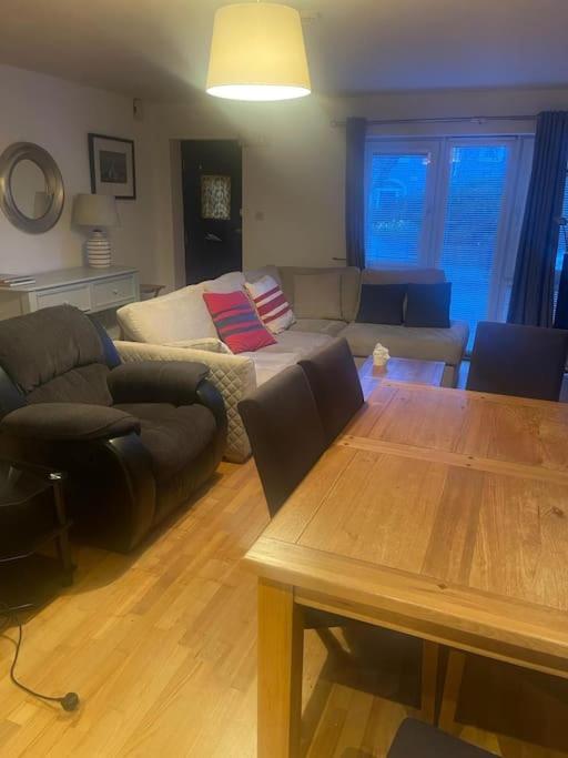 a living room with a table and a couch at Marina Apartment Kinsale in Cork