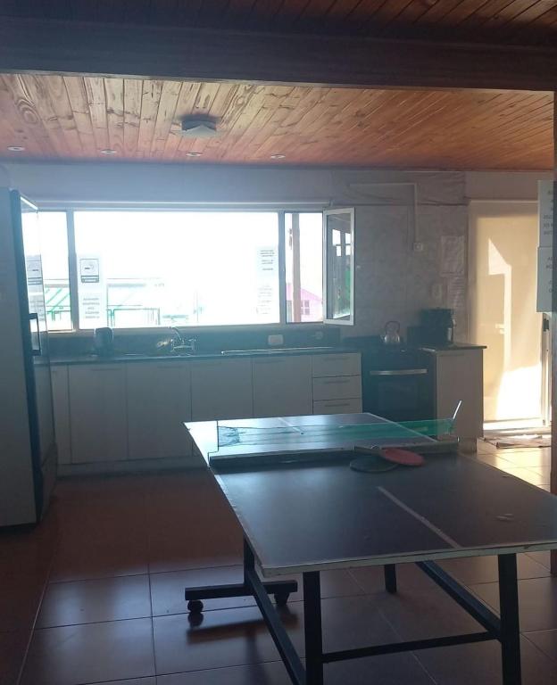 a kitchen with a table and a large window at no está disponible in Trenque Lauquen