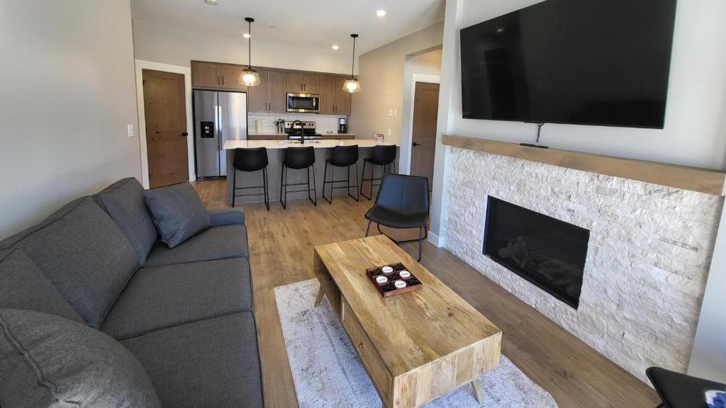 a living room with a couch and a fireplace at Powder Heights #22 townhouse in Sun Peaks